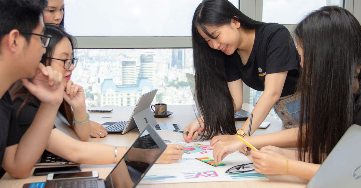 Group of colleagues engaged in a creative brainstorming session at an urban office space.