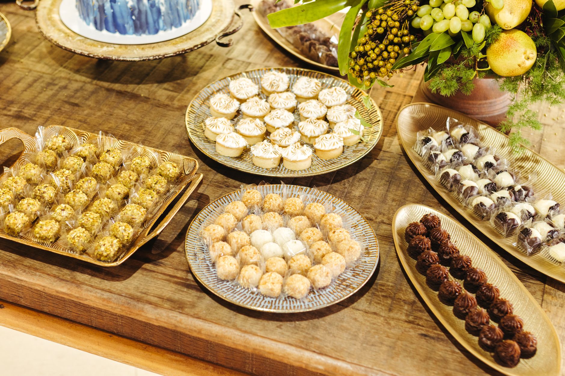 A selection of gourmet desserts displayed elegantly on a rustic wooden table, perfect for a sumptuous feast.