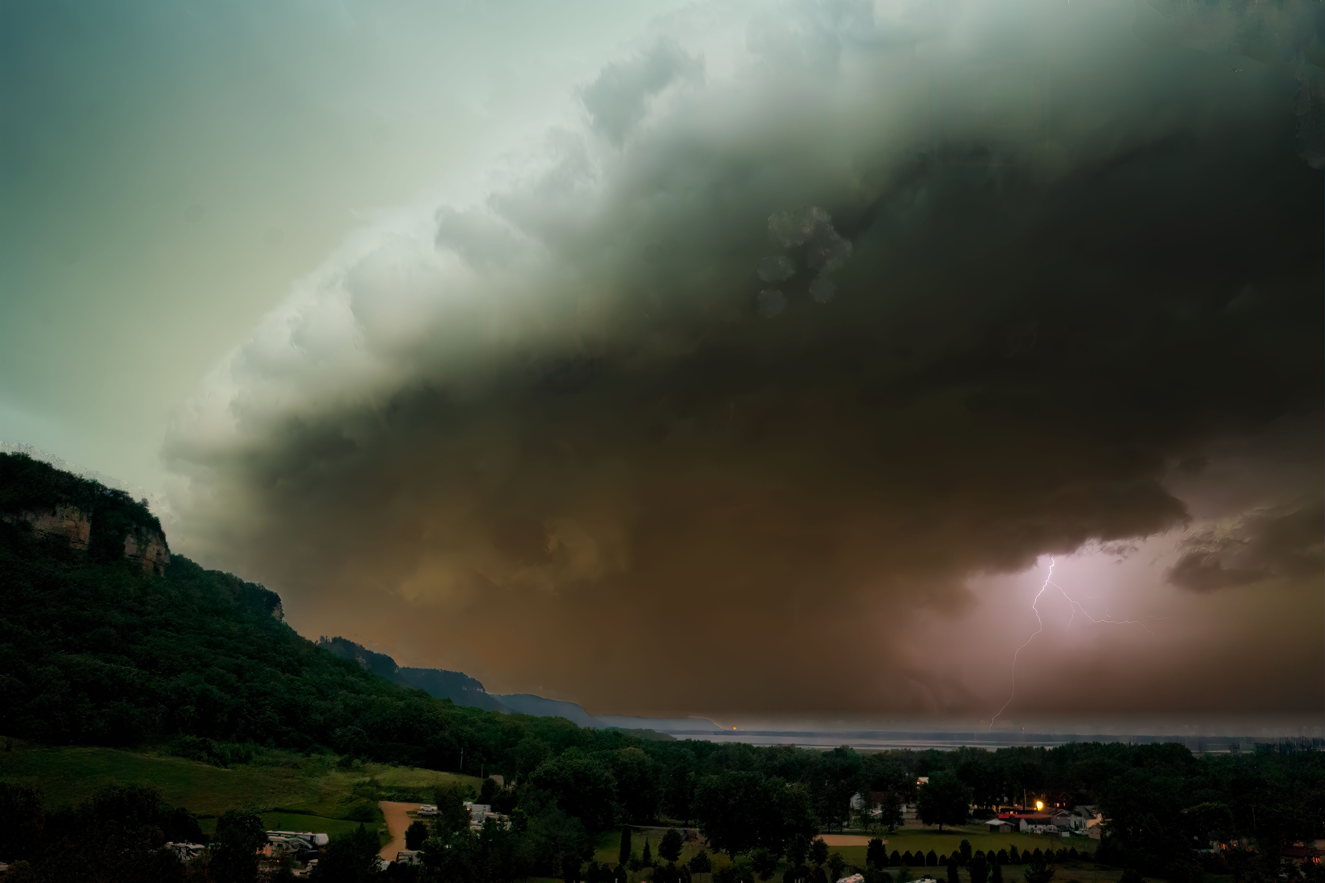A large storm cloud is seen over a city · Free Stock Photo