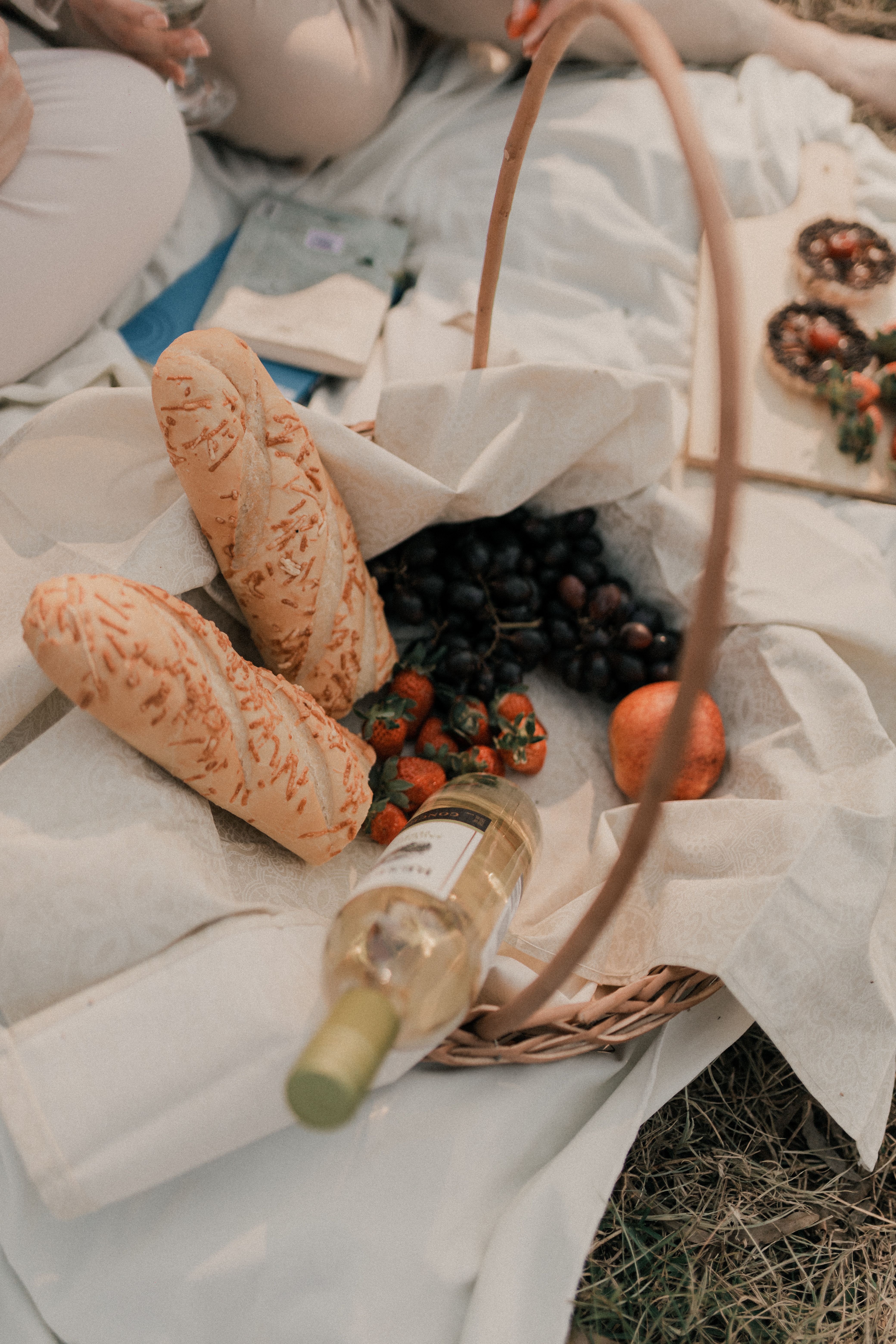 A picnic basket with bread, wine and fruit · Free Stock Photo