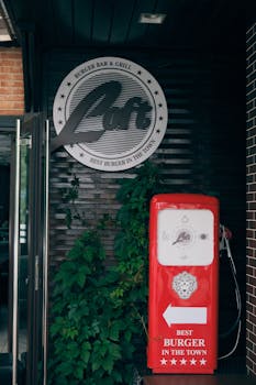 Retro style burger bar signage in Bălți, Moldova. Classic urban scene featuring a vibrant red pump.