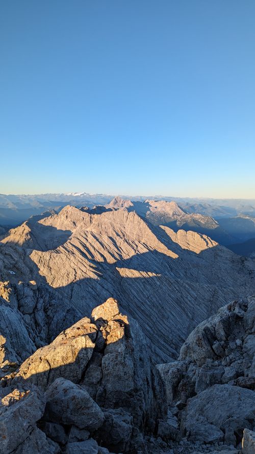 Free Majestic view of rocky mountain range illuminated by sunrise light, perfect for adventure and travel themes. Stock Photo