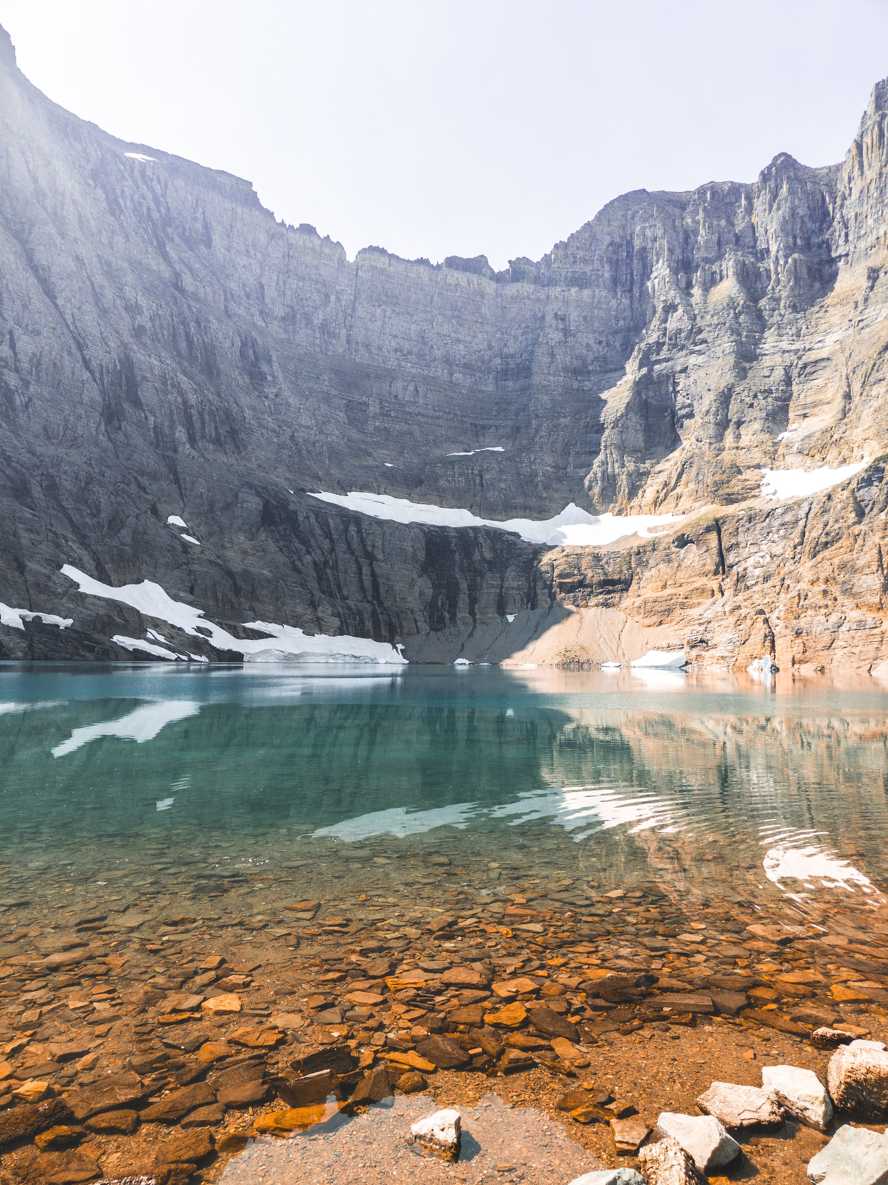 A lake surrounded by mountains and rocks · Free Stock Photo