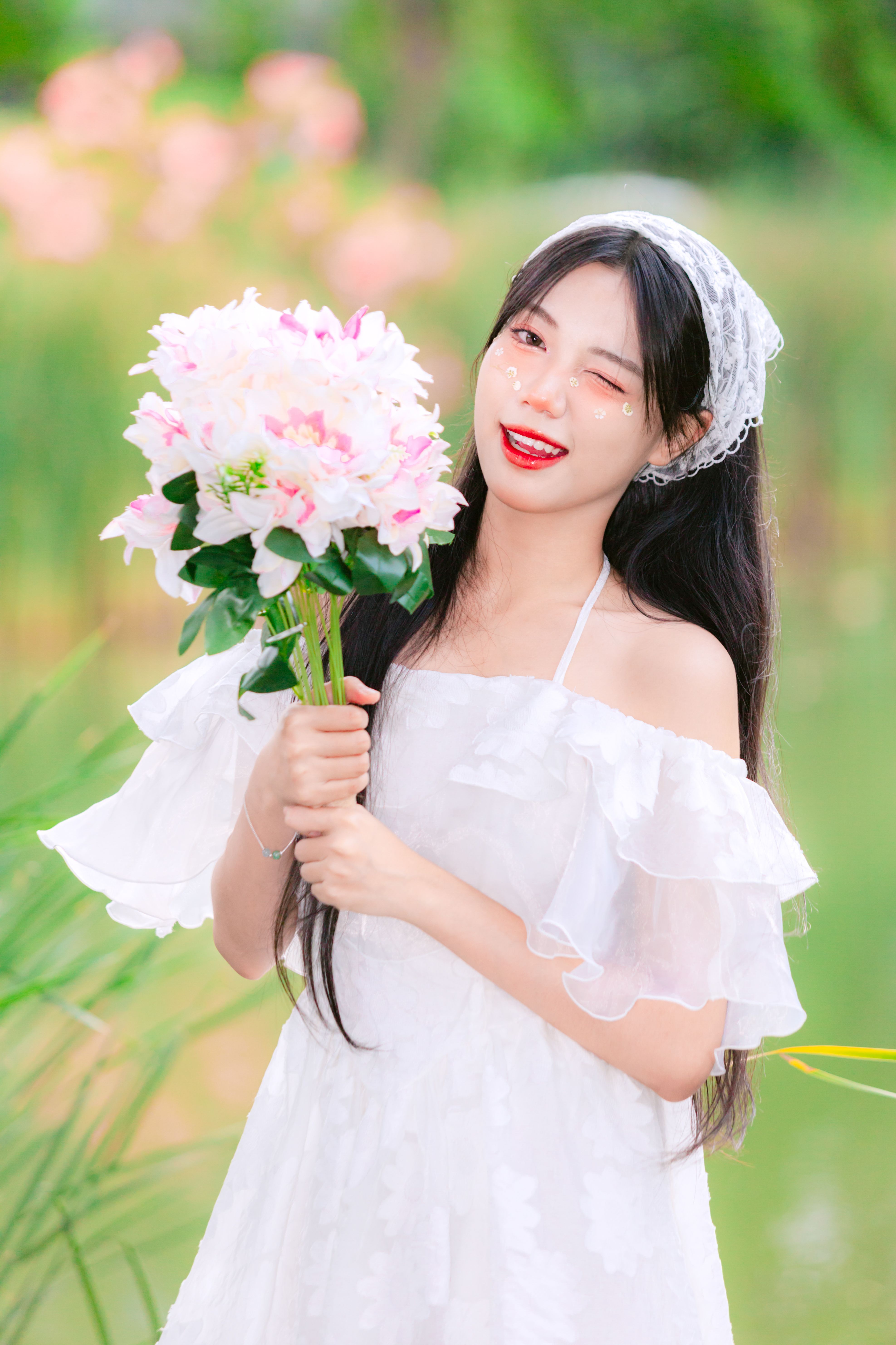 A woman in white dress holding flowers · Free Stock Photo