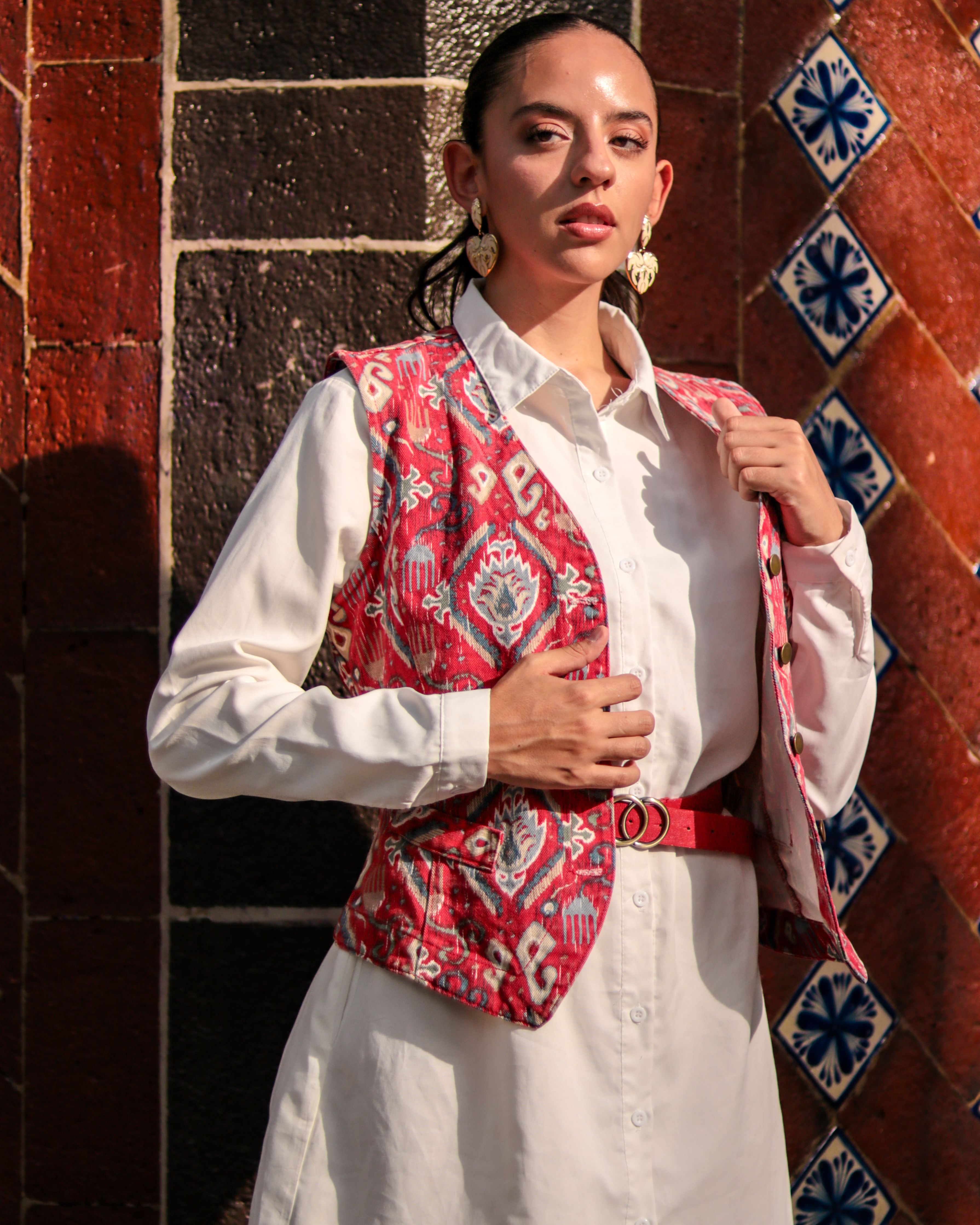 A woman in a white shirt and red vest · Free Stock Photo