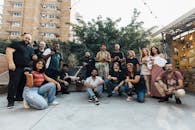 A group of people posing for a photo in a courtyard