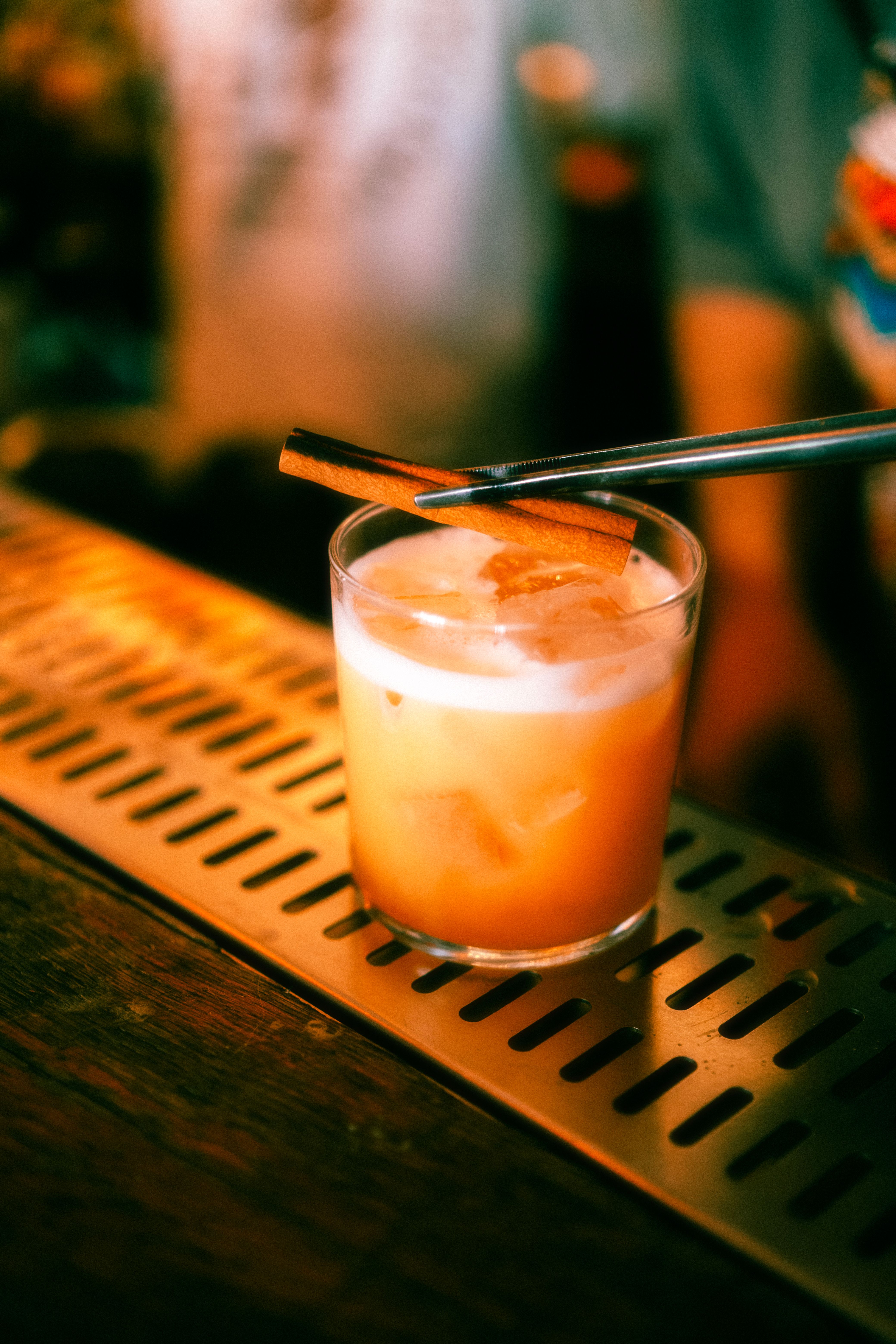 A drink with a straw and a spoon on a bar · Free Stock Photo