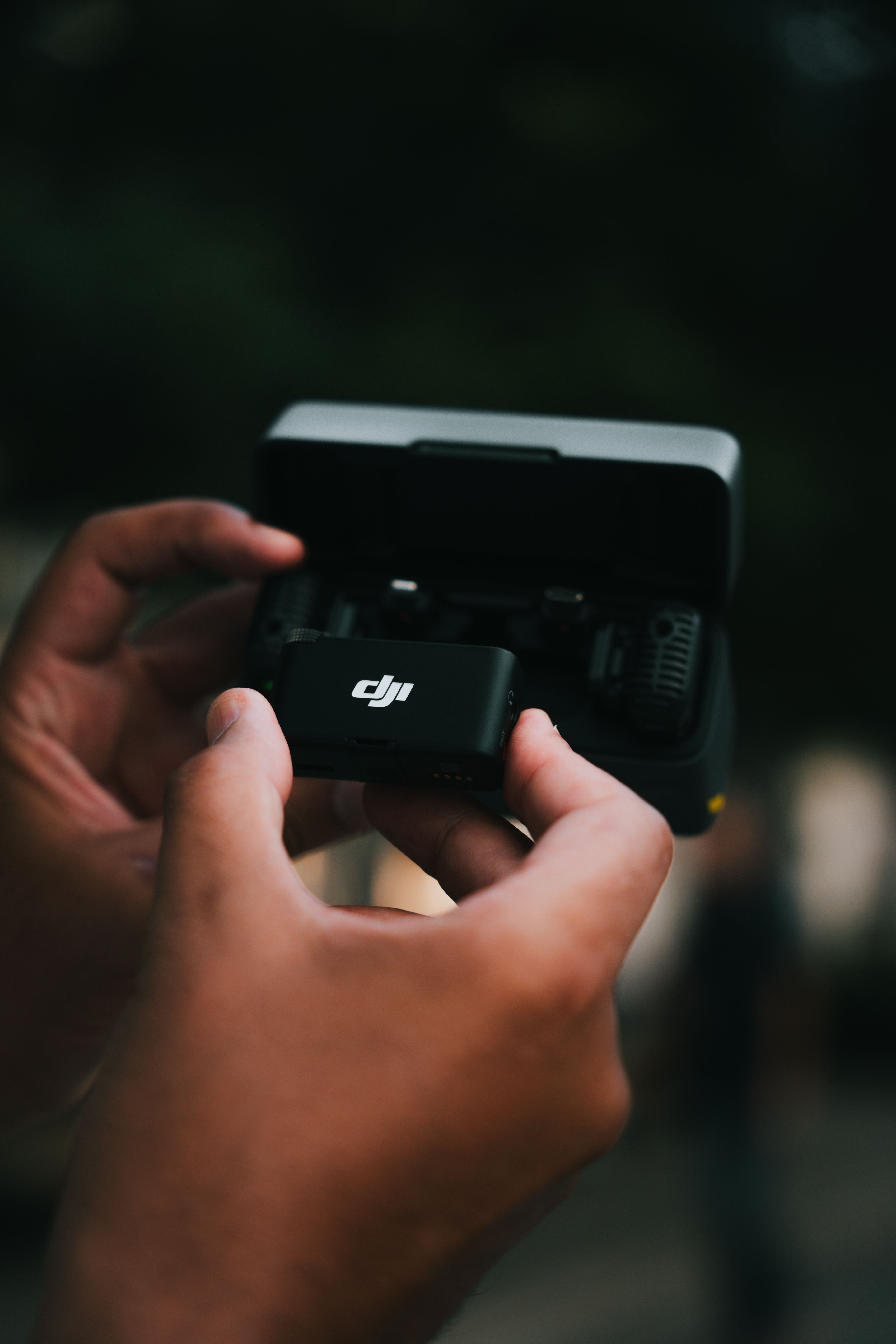 A person holding a small black camera · Free Stock Photo