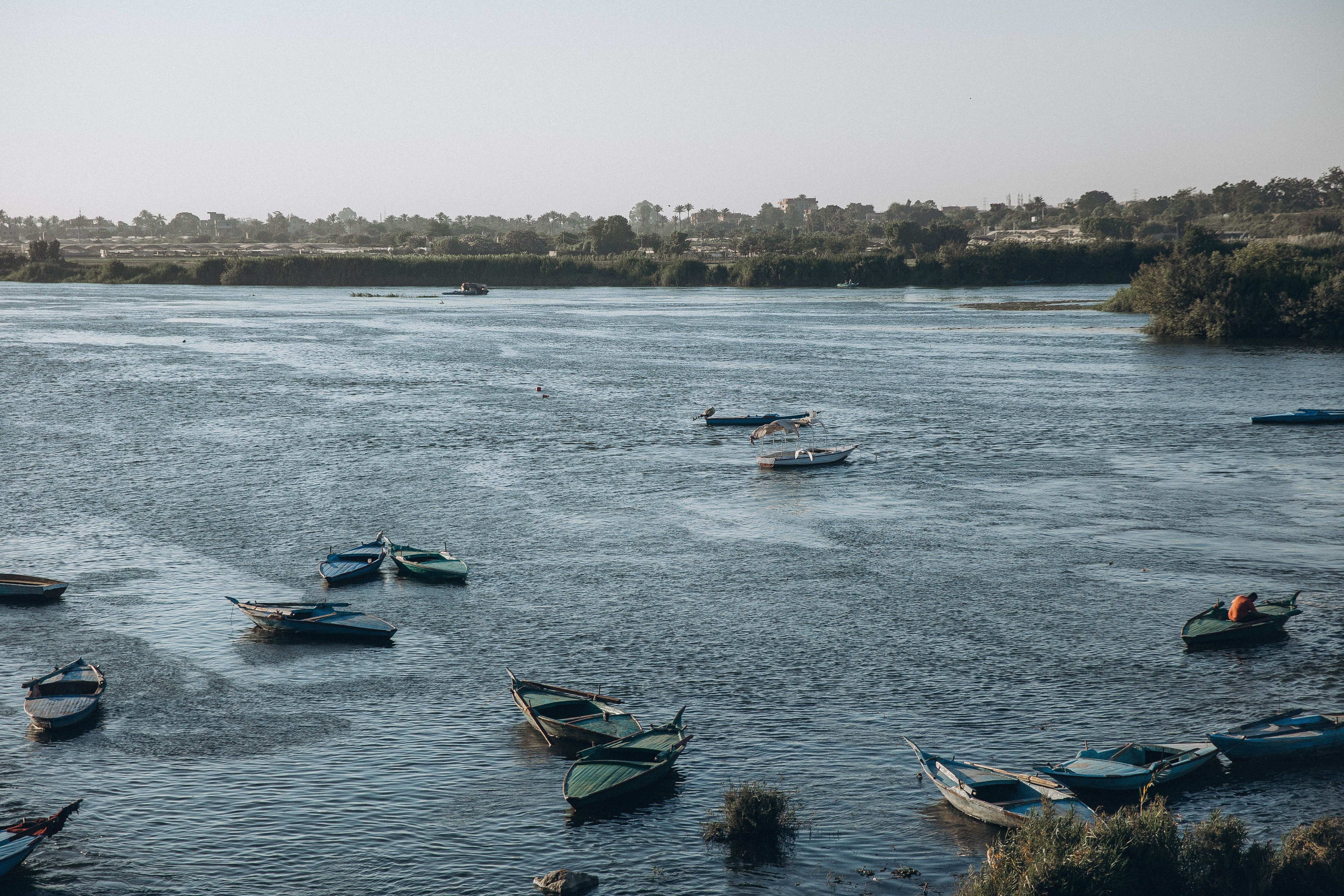 Calm day on the Nile River with colorful boats drifting. Al Qanatir Al Khayriyyah, Egypt.
