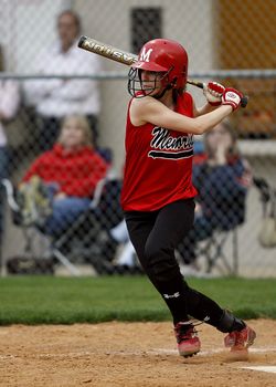 Woman Wearing Baseball Bat in Field