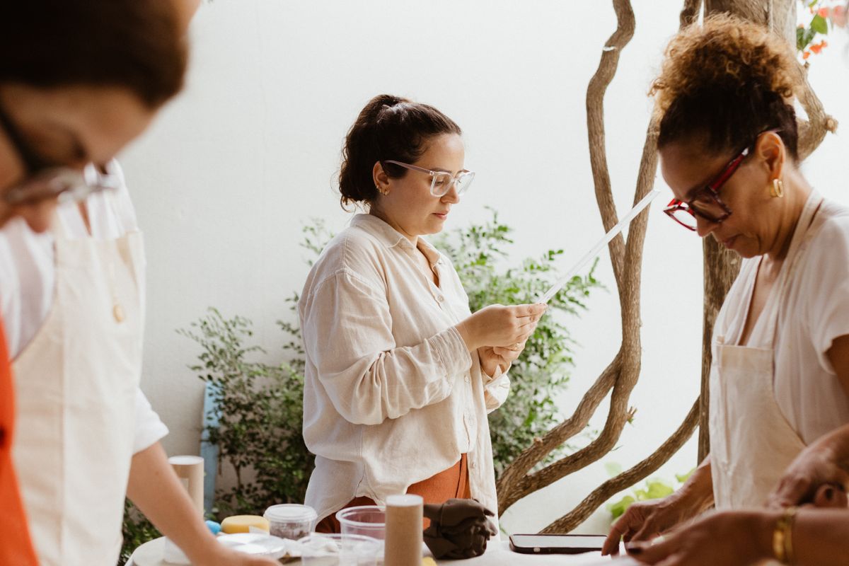 Adults shaping clay together in a bright pottery workshop — photo by Jonathan Borba on Pexels