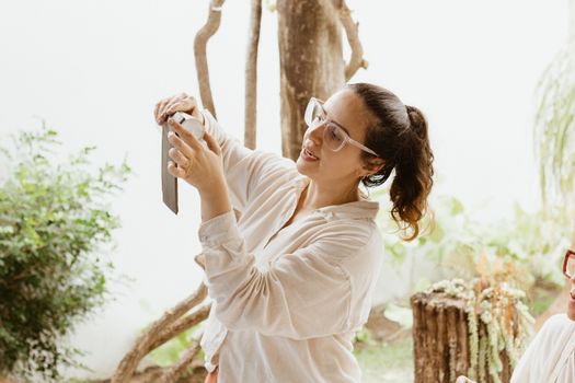 A woman taking a picture of herself with her cell phone