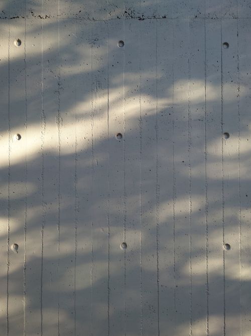 Free Abstract view of a concrete wall with light patterns creating a textured urban feel. Stock Photo