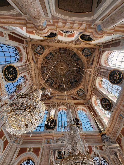 Free View of the ornate ceiling and chandeliers of Ortaköy Mosque, showcasing intricate Islamic art. Stock Photo