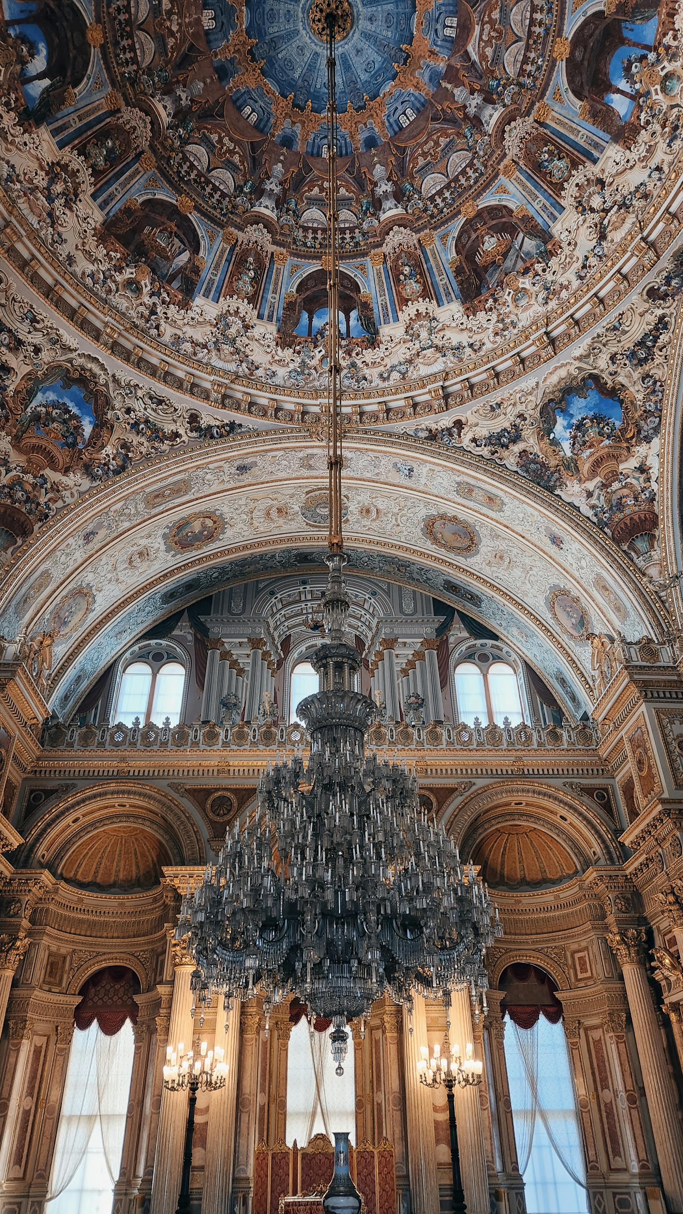 the ceiling of a large building with a chandelier