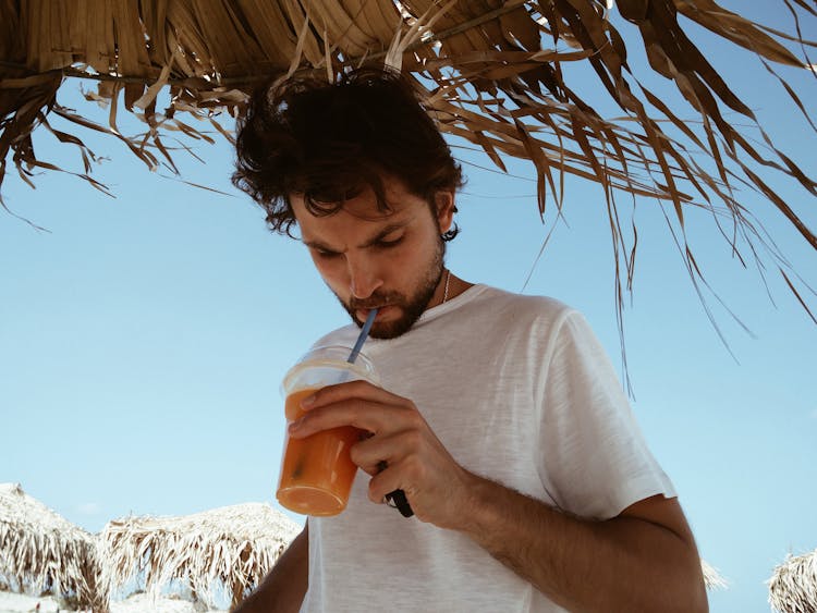 Man Sipping Orange Drink