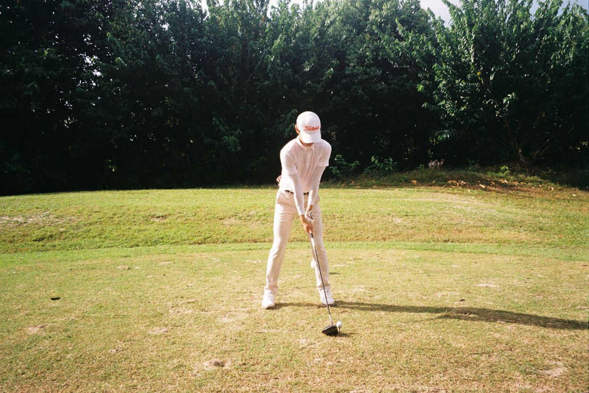 Golfer getting ready to tee off on a sunny day