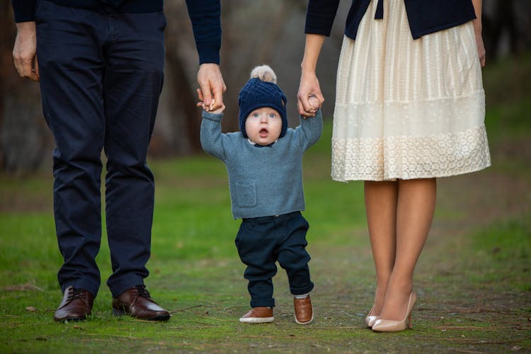 Toddler Walking With His Parents