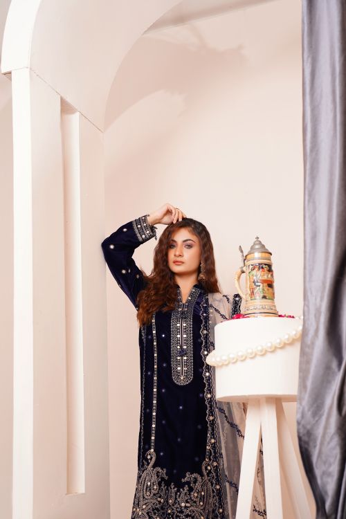 Free Stylish woman in a luxurious, bejeweled traditional eastern dress inside an elegant setting. Stock Photo