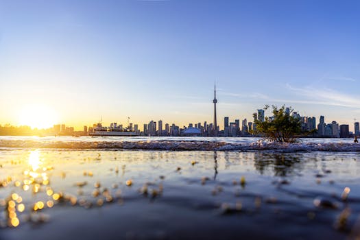 Beautiful sunset over Toronto skyline with the CN Tower and reflection on waterfront.
