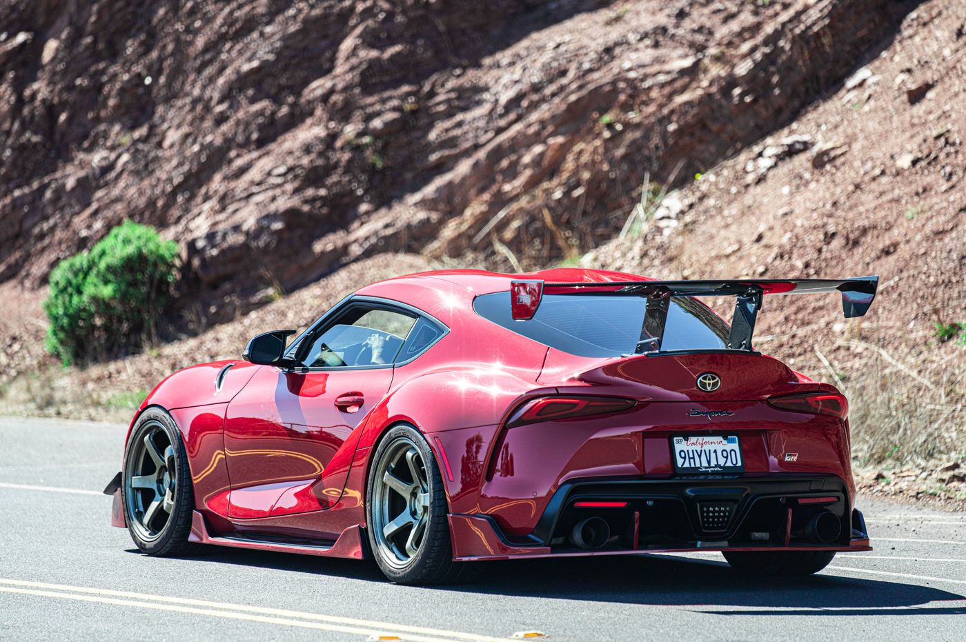 Red sports car on a scenic road