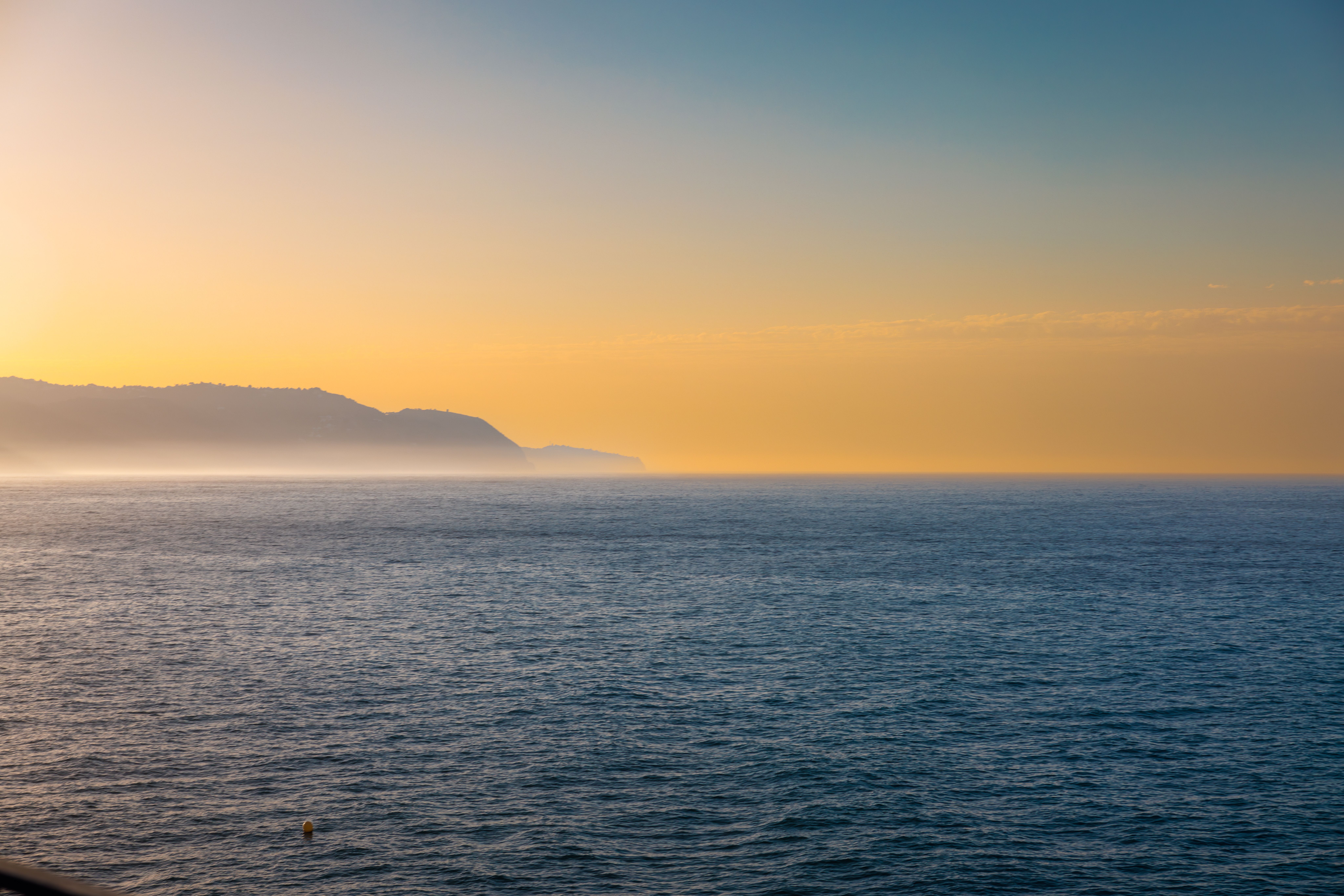 A view of the ocean at sunset with a boat in the distance · Free Stock ...