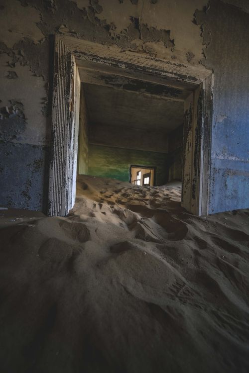 Free Explore the haunting beauty of an abandoned building filled with sand, capturing the eerie decay. Stock Photo