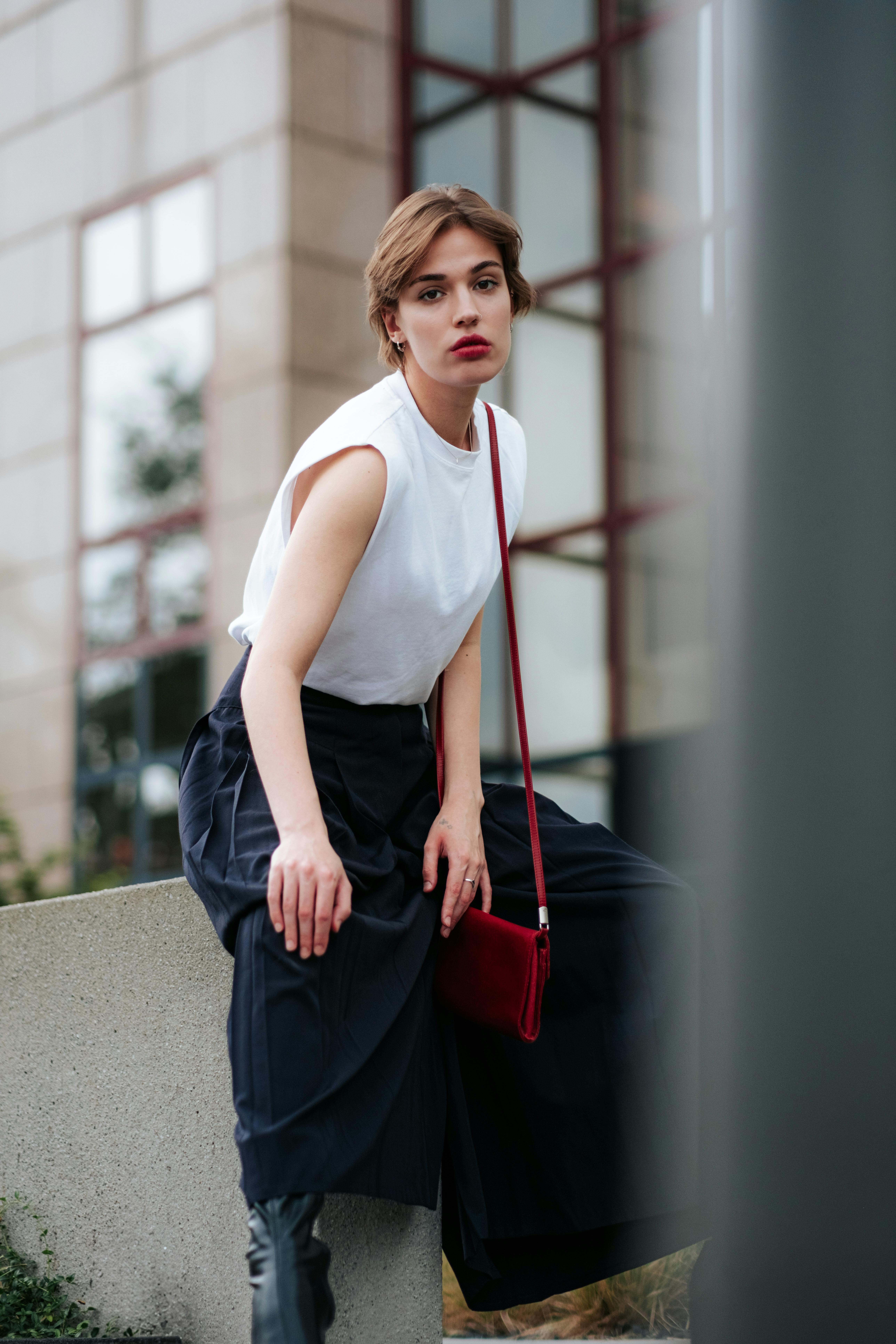 portrait of a woman sitting in front of a building