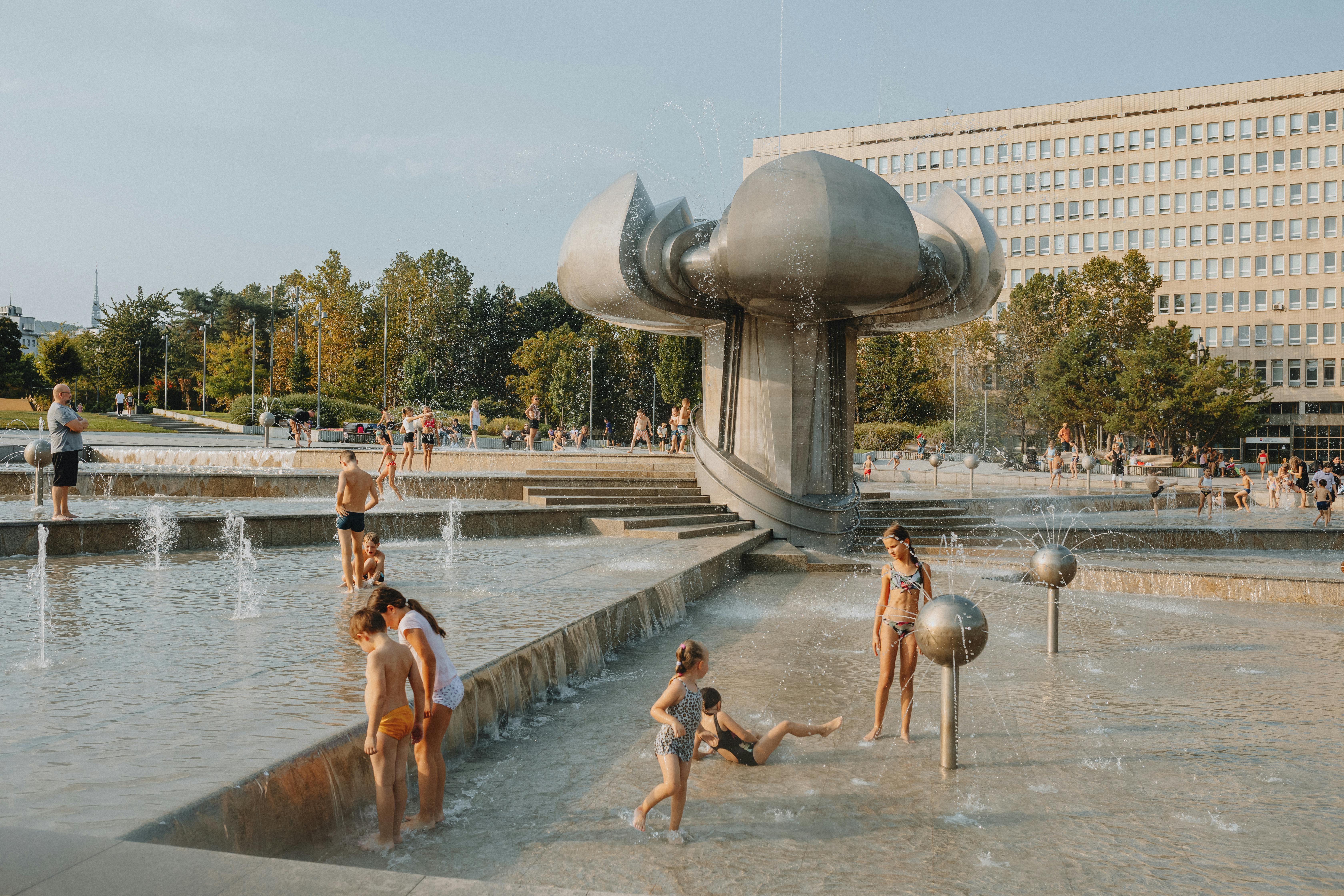 A group of people playing in a fountain