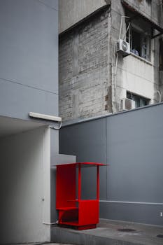 Contemporary urban architecture with a striking red element.