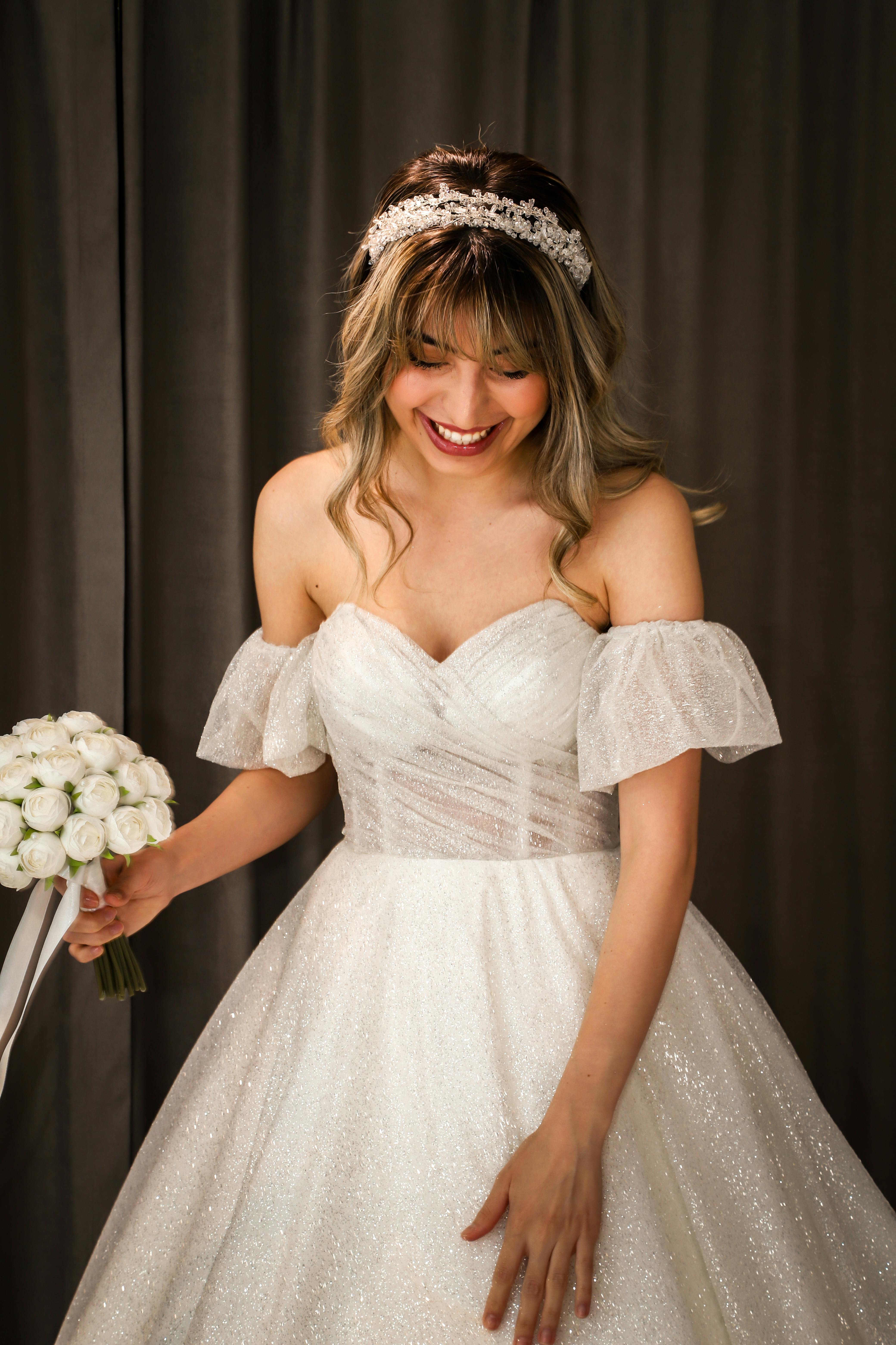 a woman in a wedding dress holding a bouquet