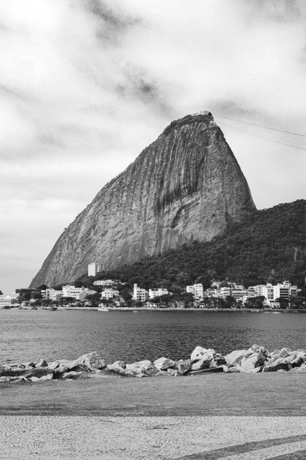 Black and white photo of Sugarloaf Mountain and Guanabara Bay in Rio de Janeiro, capturing a classic seascape view.