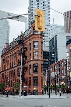 Toronto's iconic Flatiron Building amidst the modern city skyline, a blend of old and new.