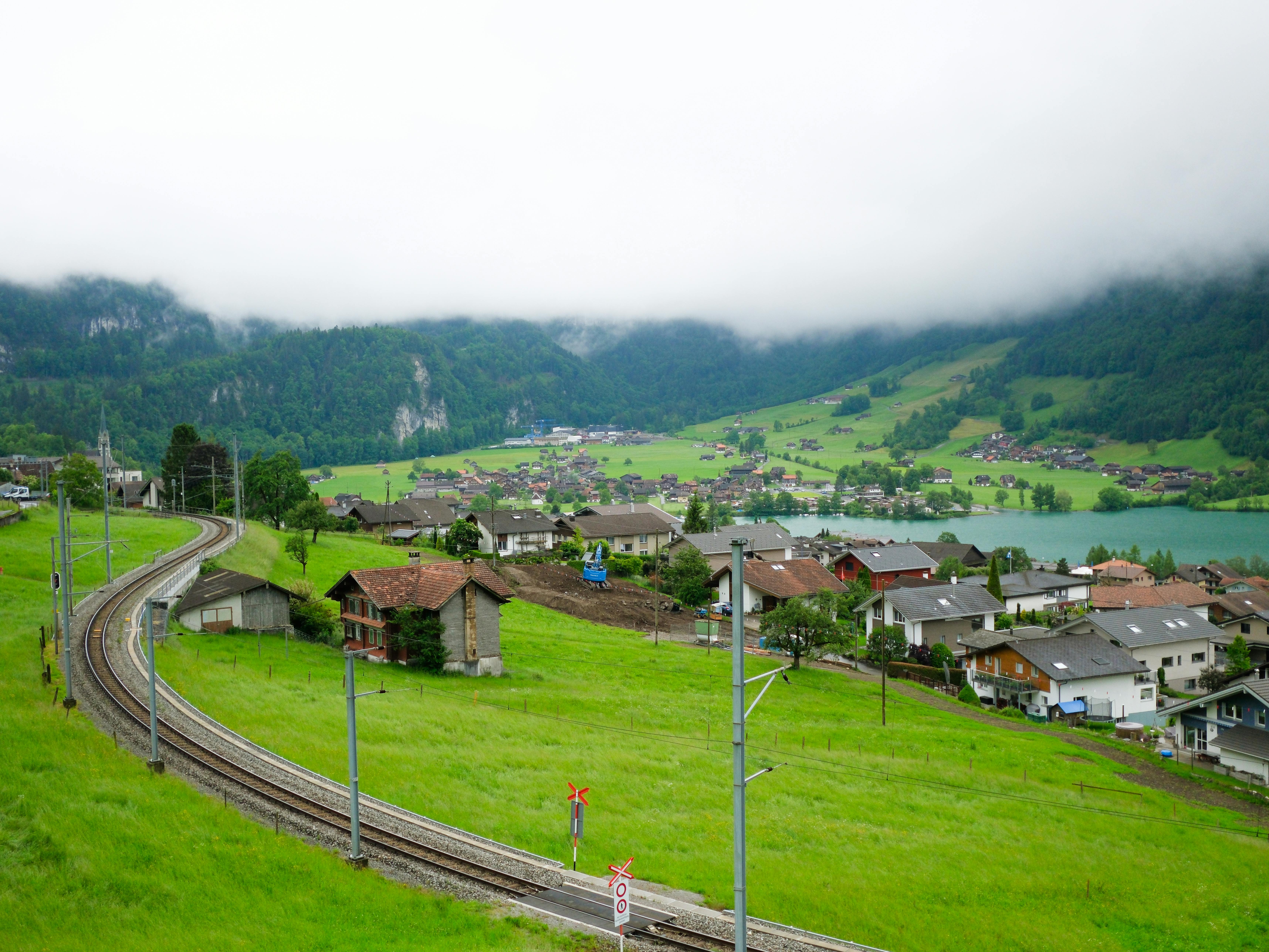 A train tracks running through a green valley