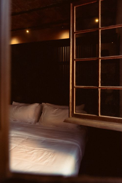Free Elegant hotel room in San Luis Potosi, Mexico featuring a cozy bed and warm lighting. Stock Photo