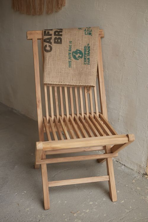 Free Wooden chair with burlap sack creates a rustic, cozy corner. Stock Photo