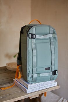 A contemporary backpack on a wooden table indoors, showcasing modern design.