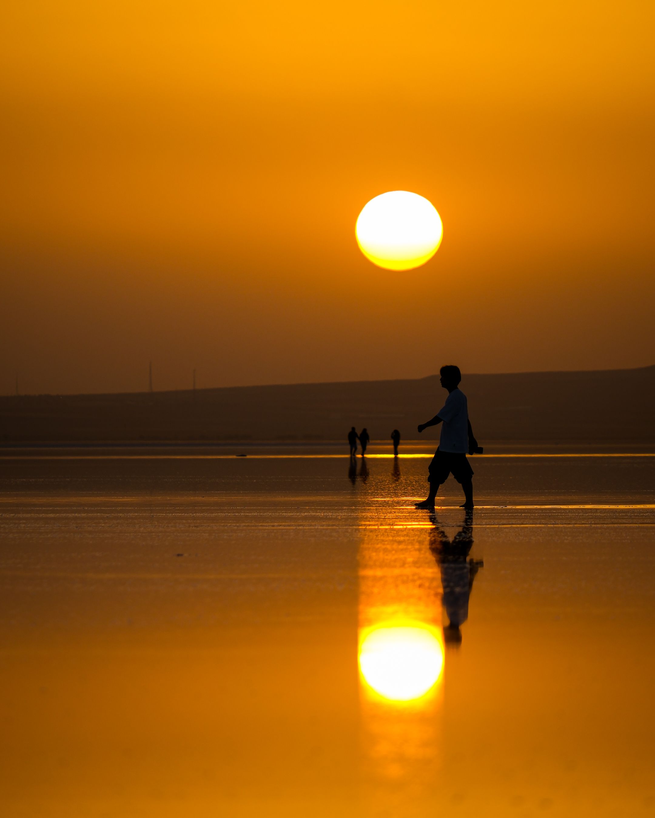 A person walking on the beach at sunset · Free Stock Photo