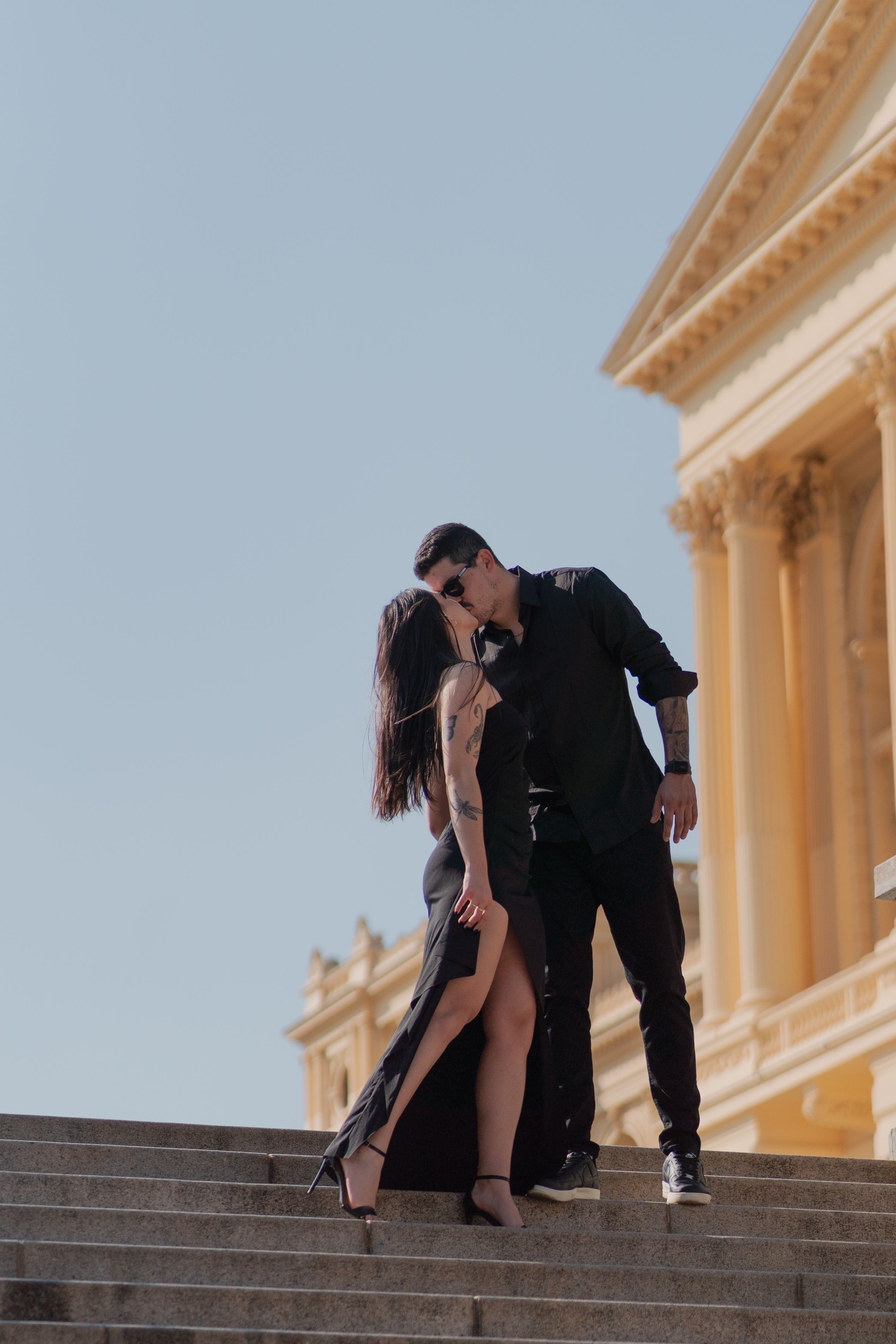 A couple kissing on the steps of a building · Free Stock Photo