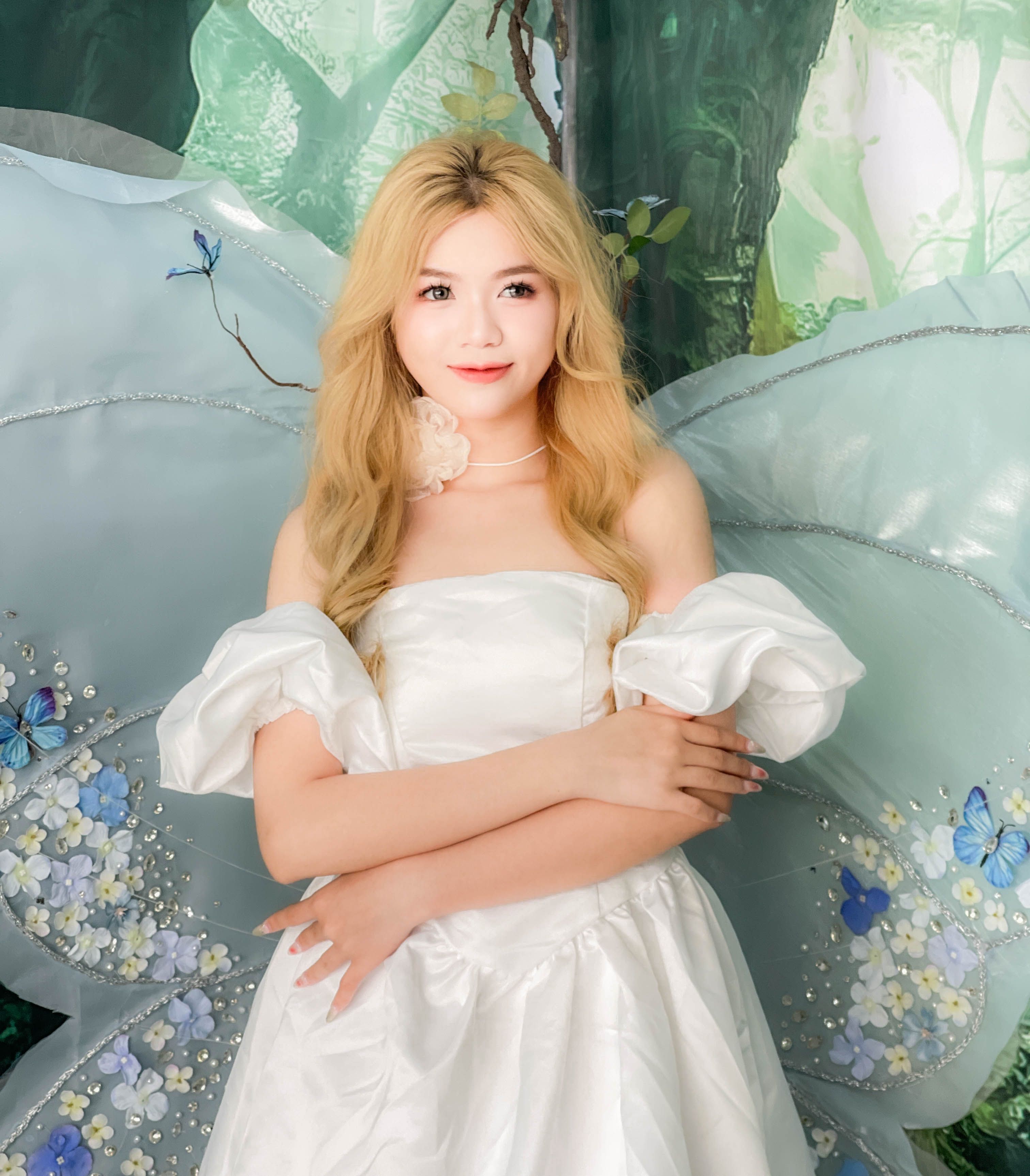 A woman in a white dress with a butterfly on her shoulder · Free Stock ...