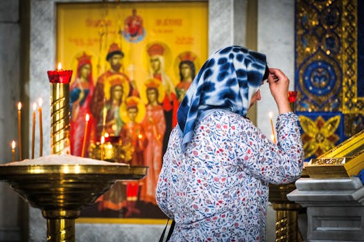 A woman engaged in prayer inside a church in Moscow, featuring religious icons.