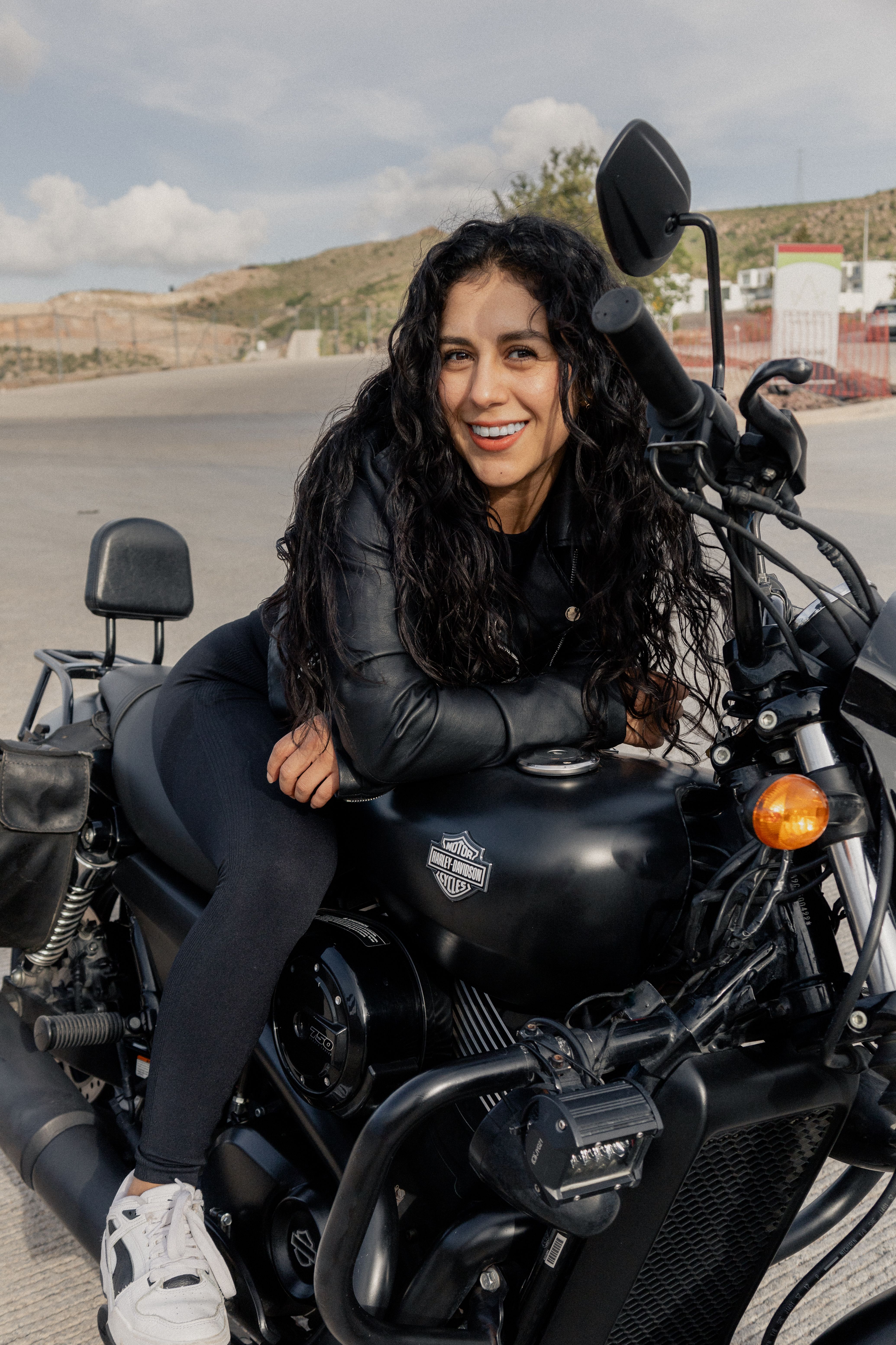 Empowered woman on a black motorcycle in San Luis Potosí, Mexico, exuding confidence and style.