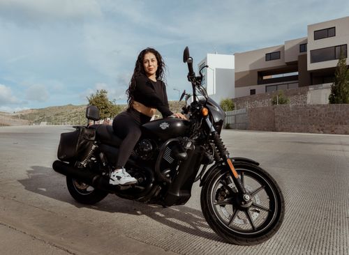 Free A woman confidently sits on a sleek black motorcycle on a bright day in San Luis Potosí, Mexico. Stock Photo