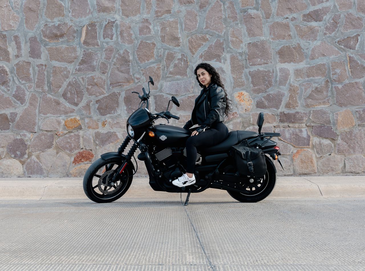 a woman sits confidently on a black motorcycle in san luis potos outdo