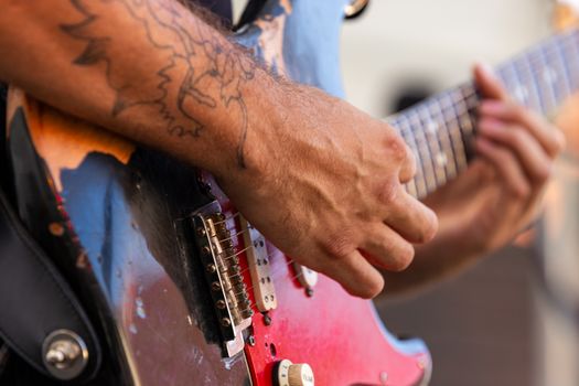 Detailed view of a musician's hand playing an electric guitar during a performance.. detailed, view, musicians