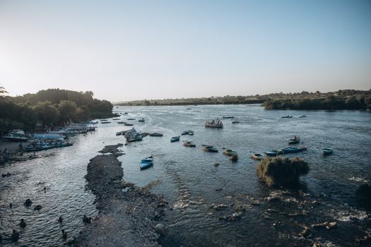 Peaceful river scene with boats on the Nile in Al Qanatir Al Khayriyyah, Egypt at sunset.