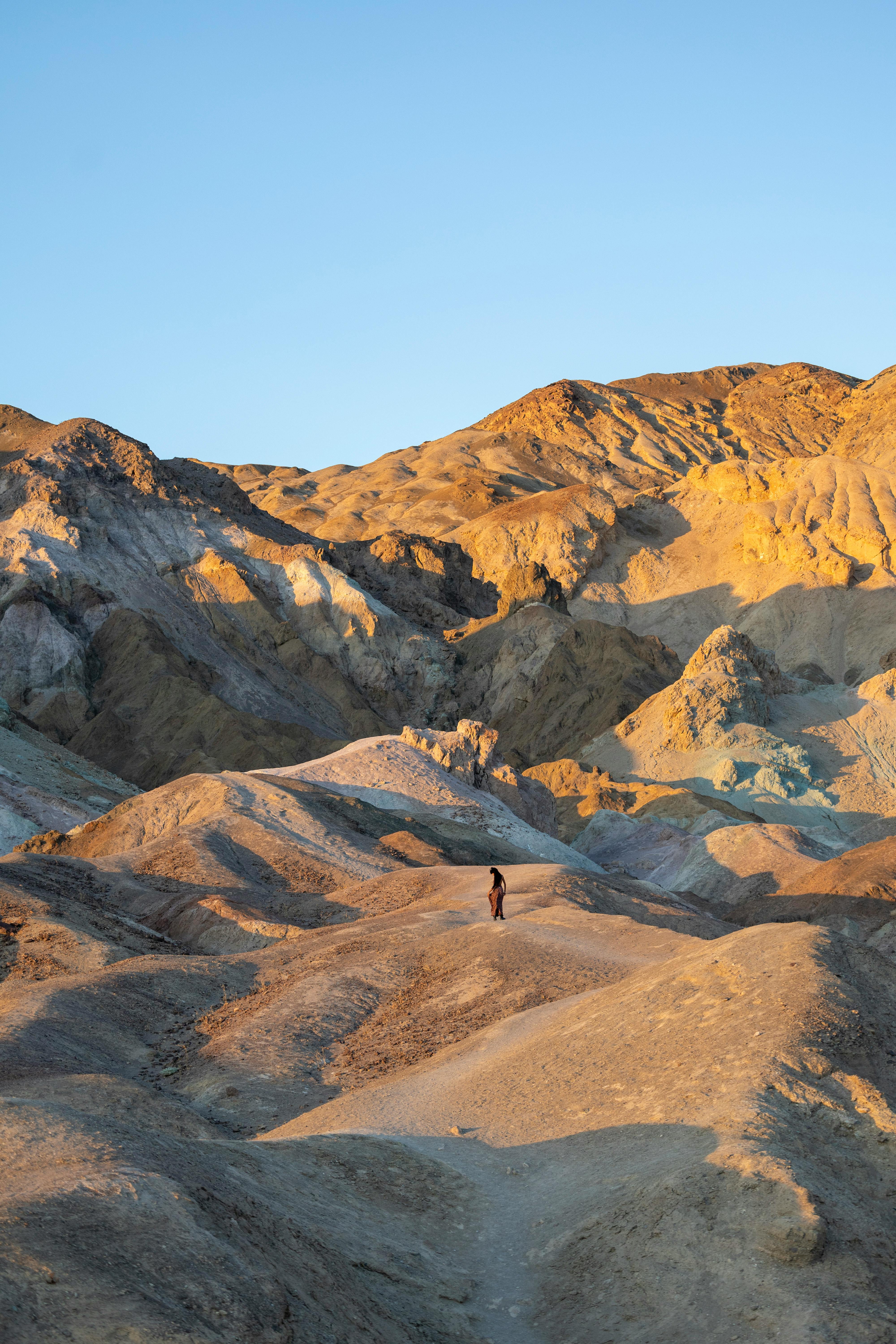 a person walking through the desert in death valley