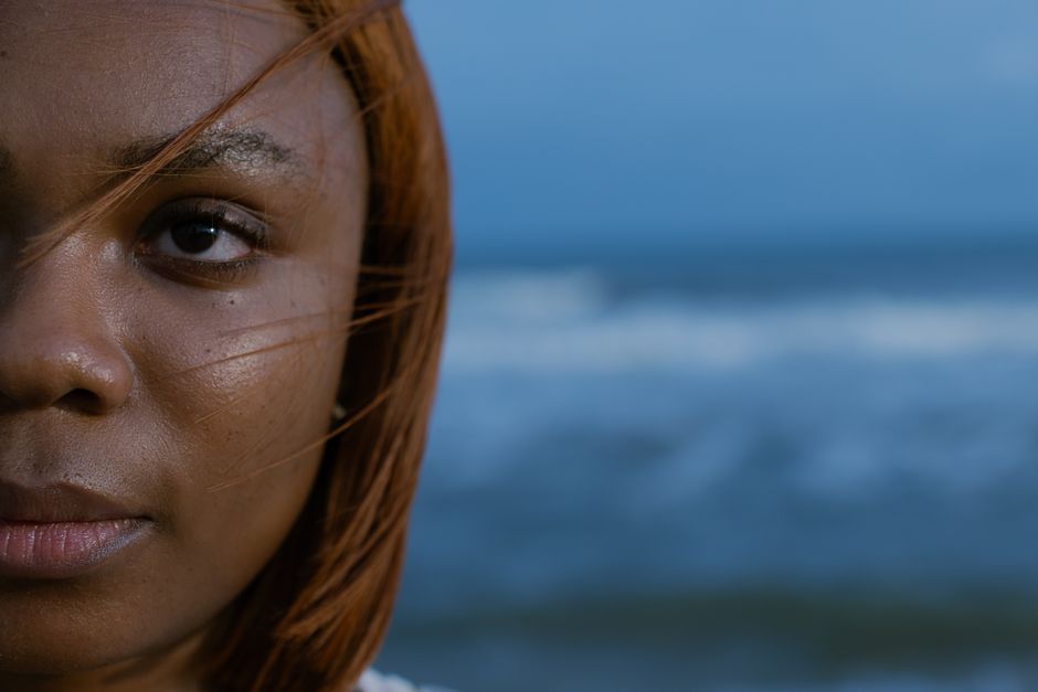 Captivating close-up portrait of a woman by the serene Lagos coastline.