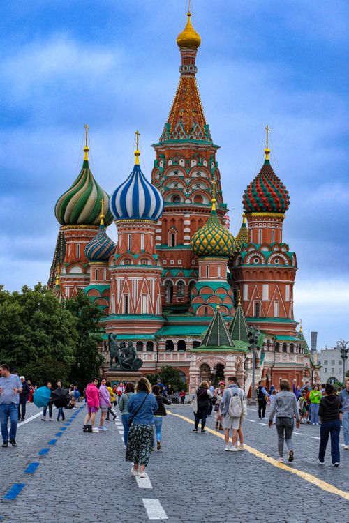 Free Tourists explore the iconic St. Basil's Cathedral in Moscow's Red Square on a lively day. Stock Photo
