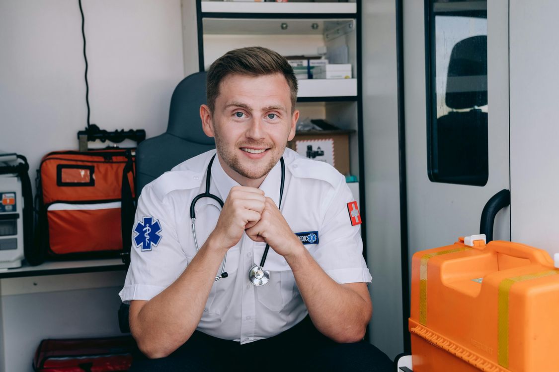 Smiling Paramedic in Ambulance · Free Stock Photo